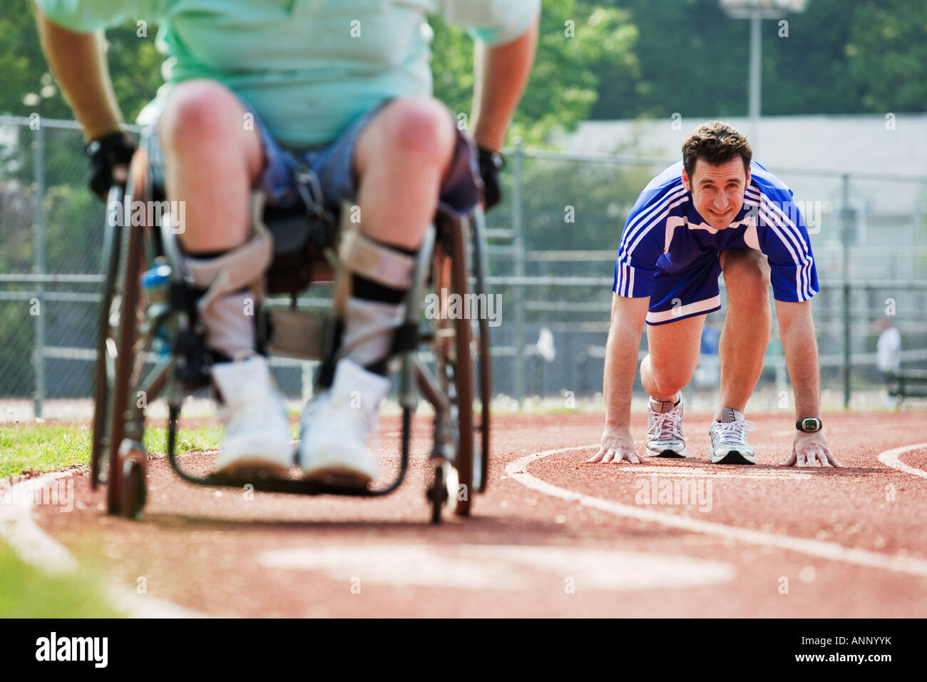 Young man racing with a handicapped senior man on a racetrack Stock ...