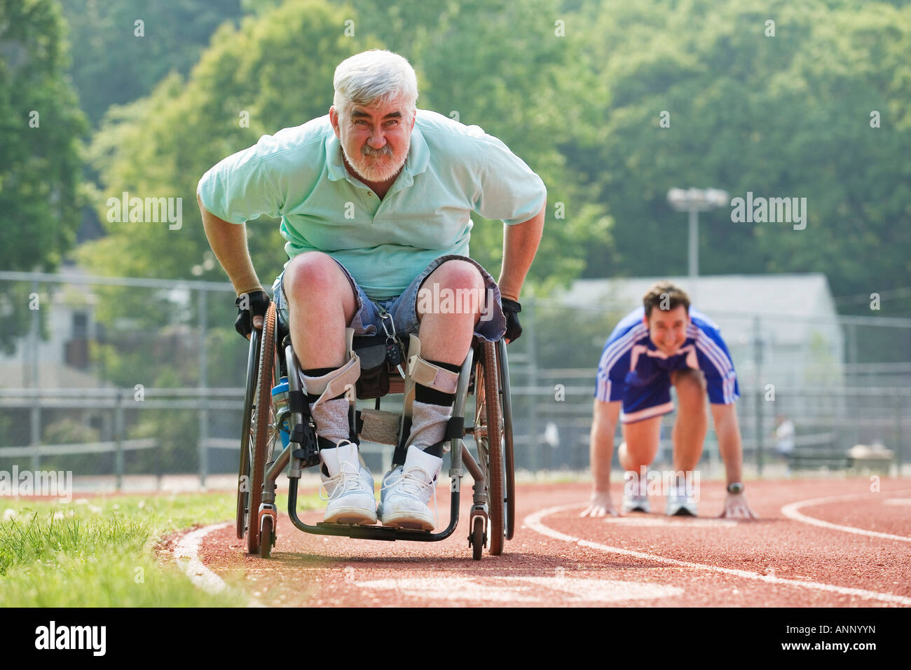 View of a young man racing with a handicapped senior man Stock Photo ...