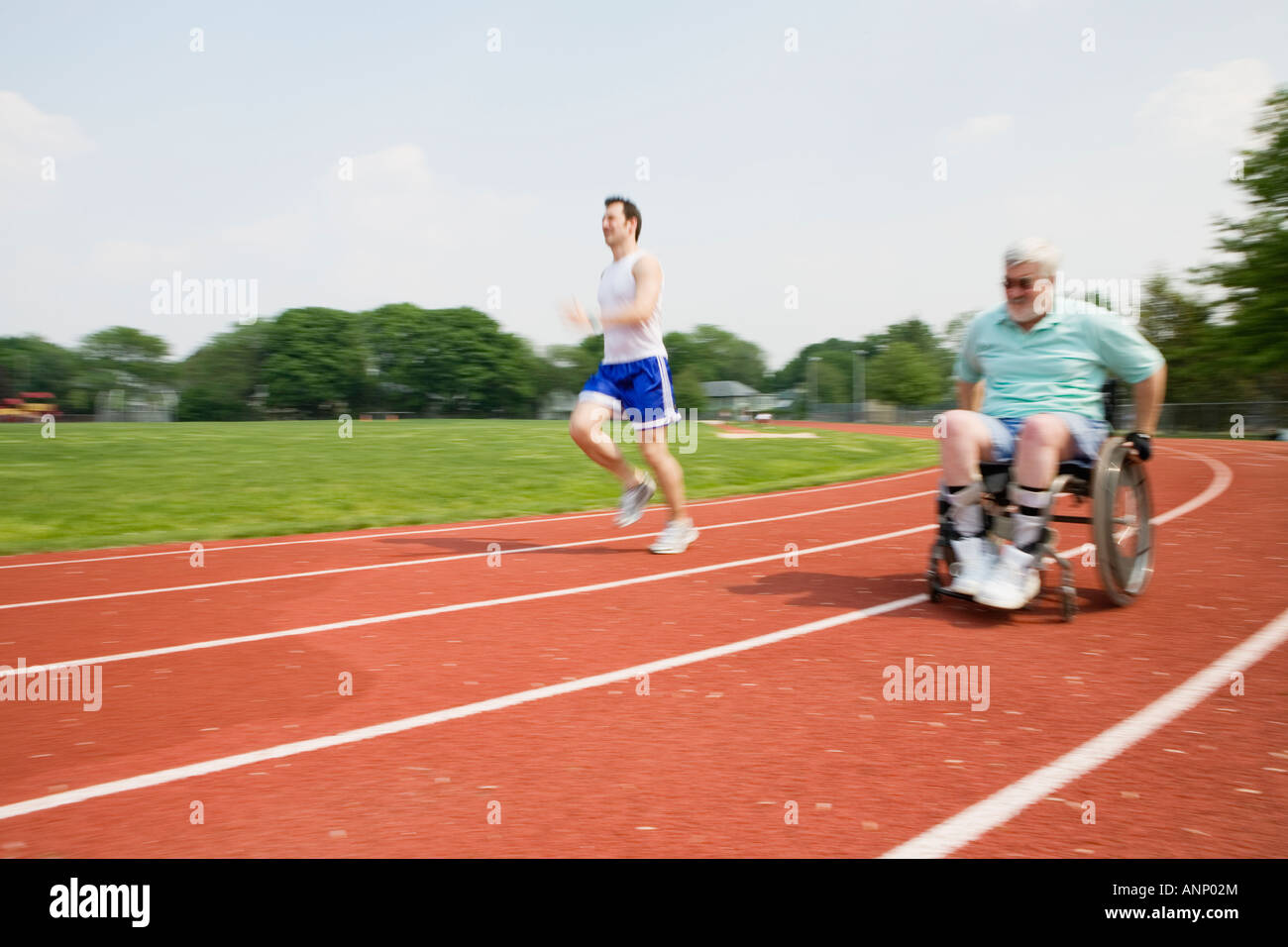 Young man racing with a handicapped senior man on a racetrack Stock ...