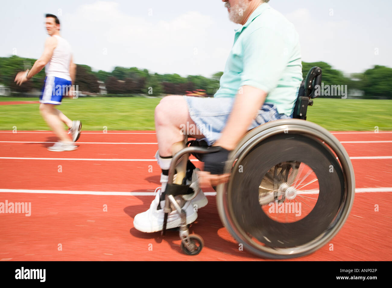 Young man racing with a handicapped senior man on a racetrack Stock ...