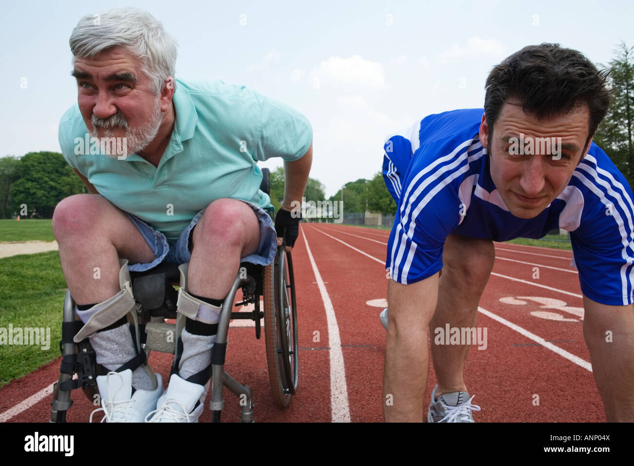 Young man racing with a handicapped senior man on a racetrack Stock ...