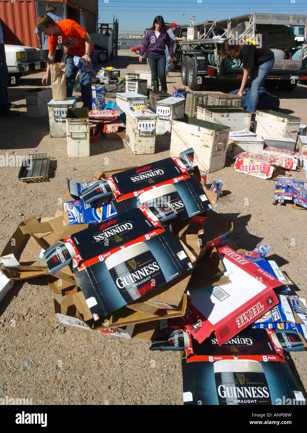 People packing several dozen cases of beer into army surplus rocket boxes for a whitewater river rafting trip Stock Photo