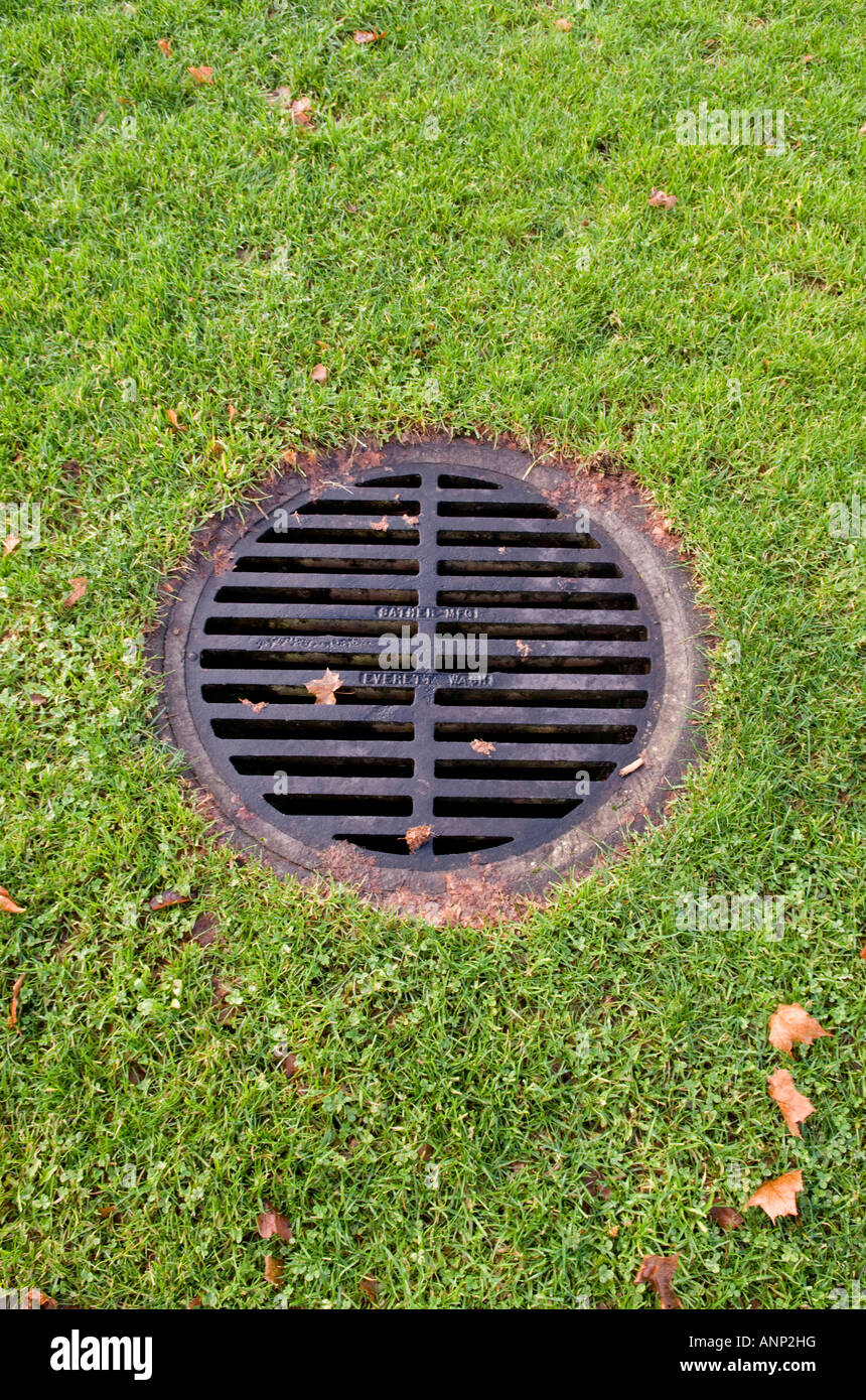 Storm sewer drain in a grassy area Stock Photo