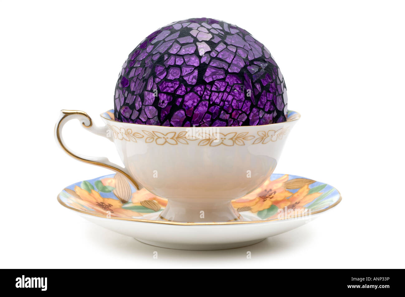 Purple glass  crystal ball in a "Queens china" "art deco" cup and saucer Stock Photo