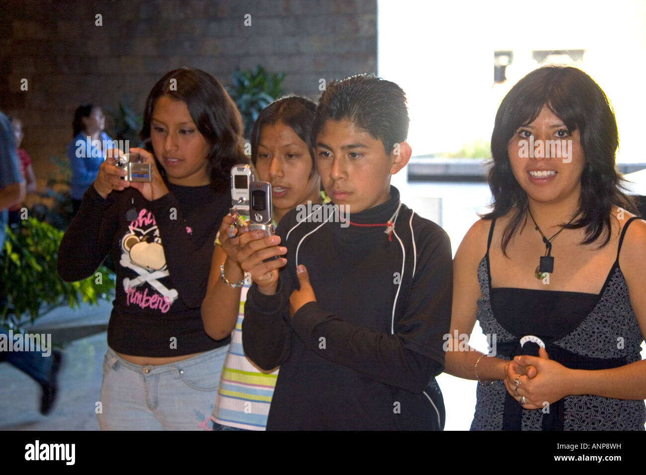 Mexican teens use cell phone cameras at the National Museum of Anthropology in Mexico City Mexico Stock Photo