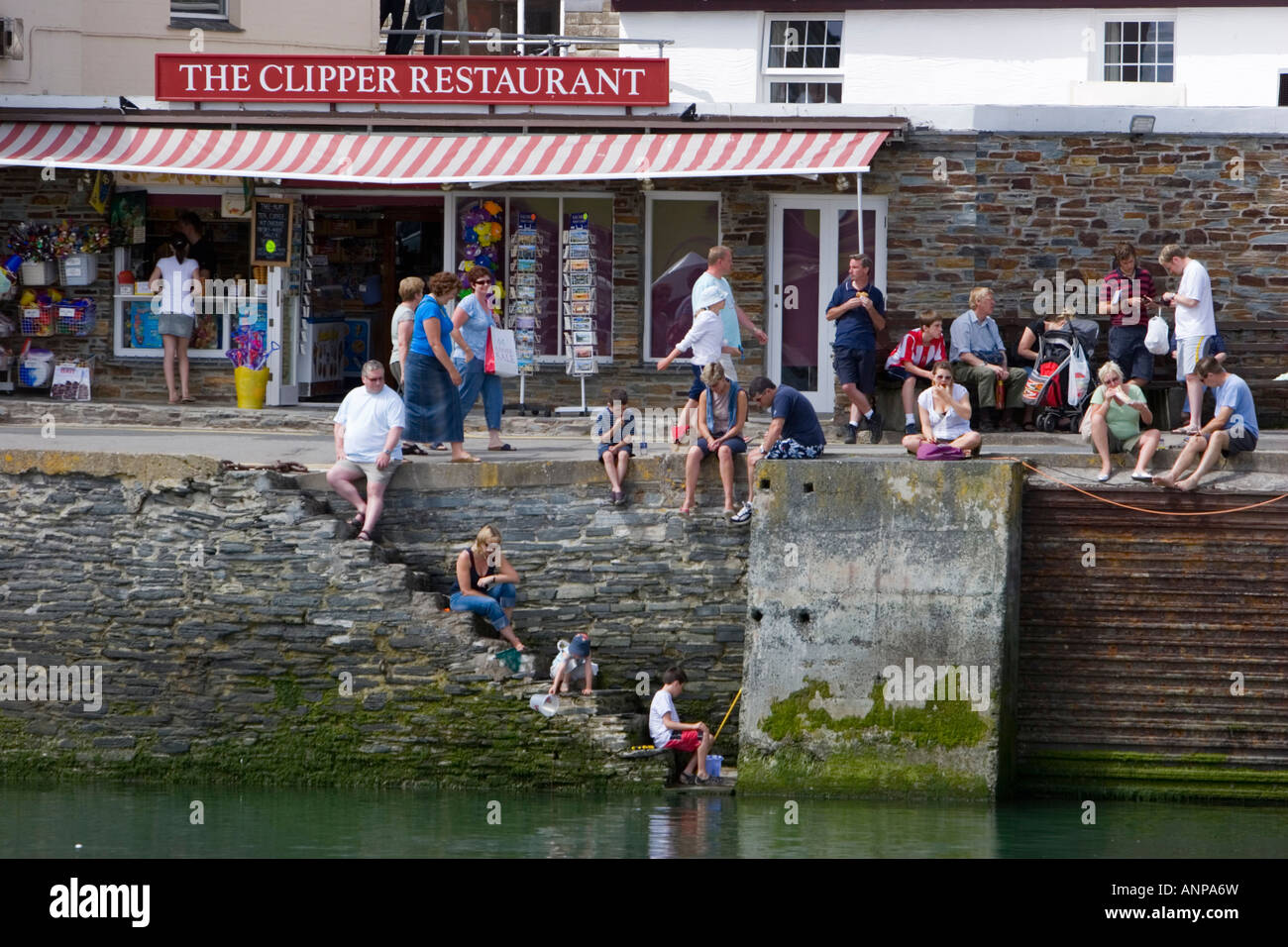 Crabbing on the steps of Padstow harbour in north Cornwall Stock Photo Alamy