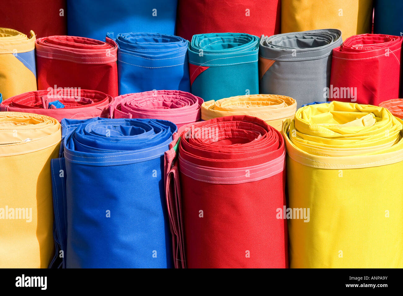 Rolls of colored canvas being sold at the Merced Market in Mexico City Mexico Stock Photo