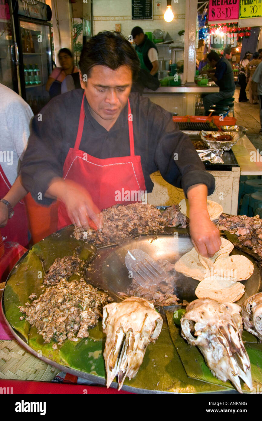 Vendor cooking cabeza tacos using a cazo at the Merced Market in Mexico City Mexico Stock Photo