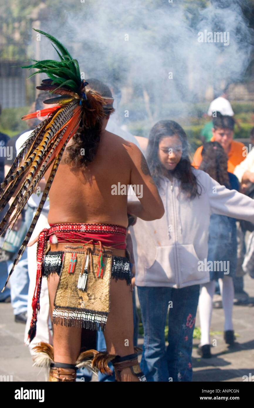 Aztec indian in traditional dress performing a spiritual ceremony with smoke on the Day of the Dead in Mexico City Mexico Stock Photo