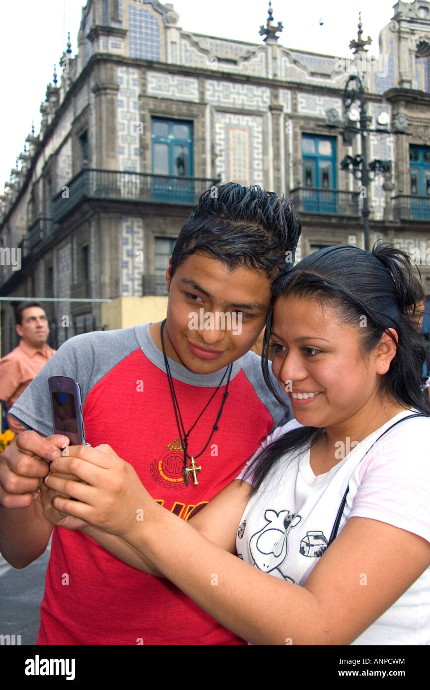 Mexican teens view photos taken with a cell phone in Mexico City Mexico Stock Photo