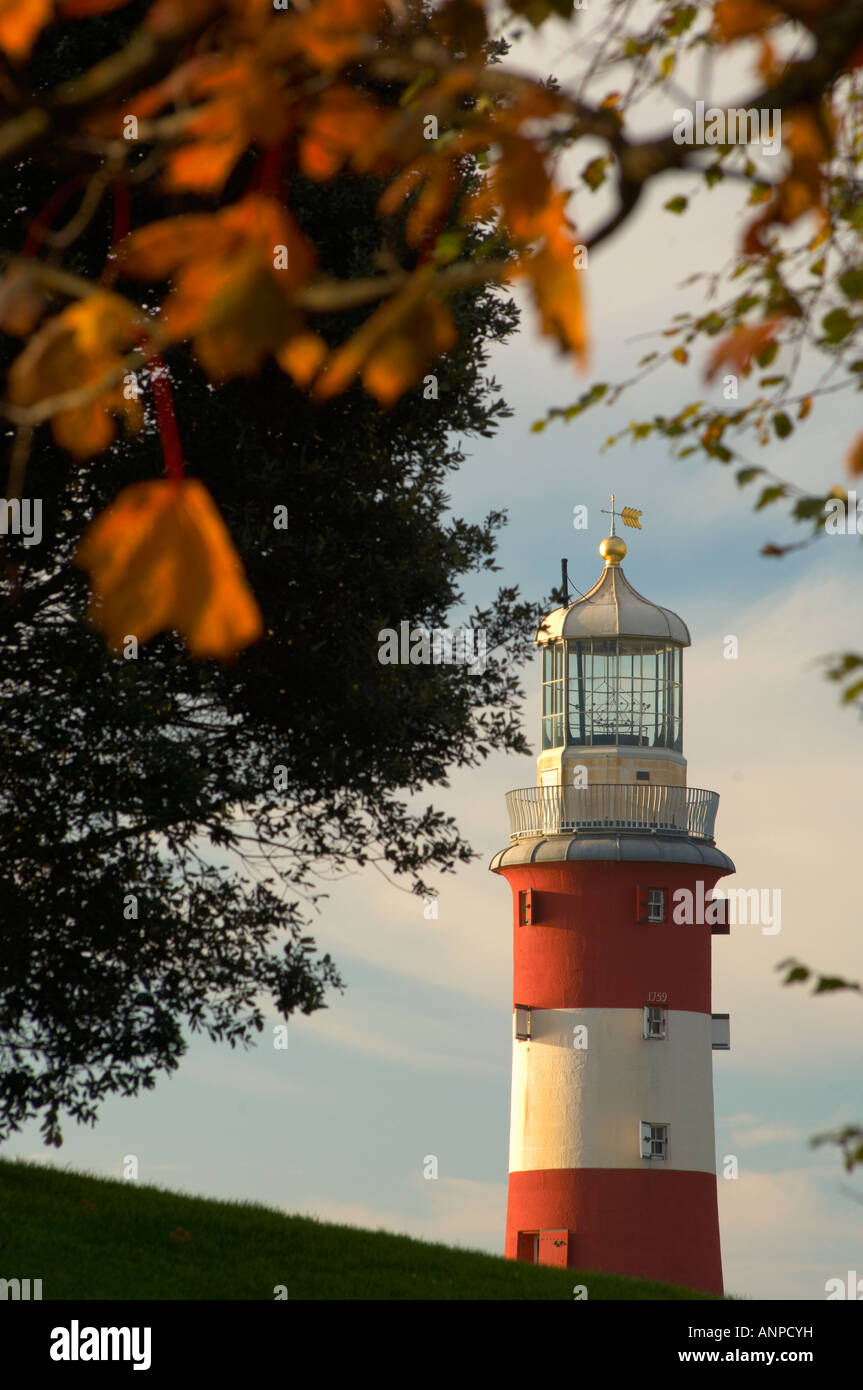 The top of Smeatons Tower lighthouse viewed through autumnal trees