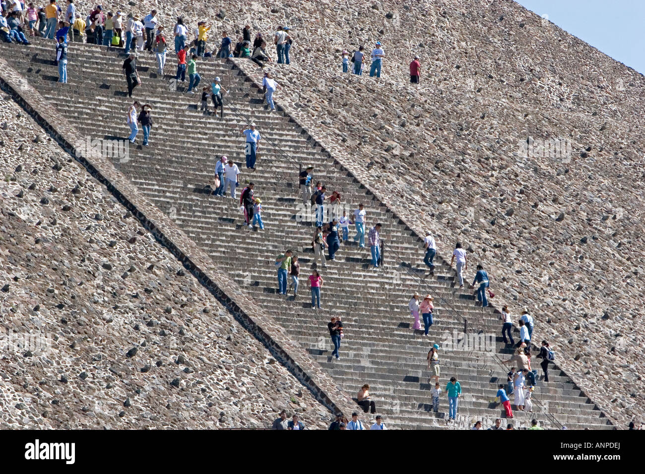 Tourists climb the steps of the Pyramid of the Sun at Teotihuacan in