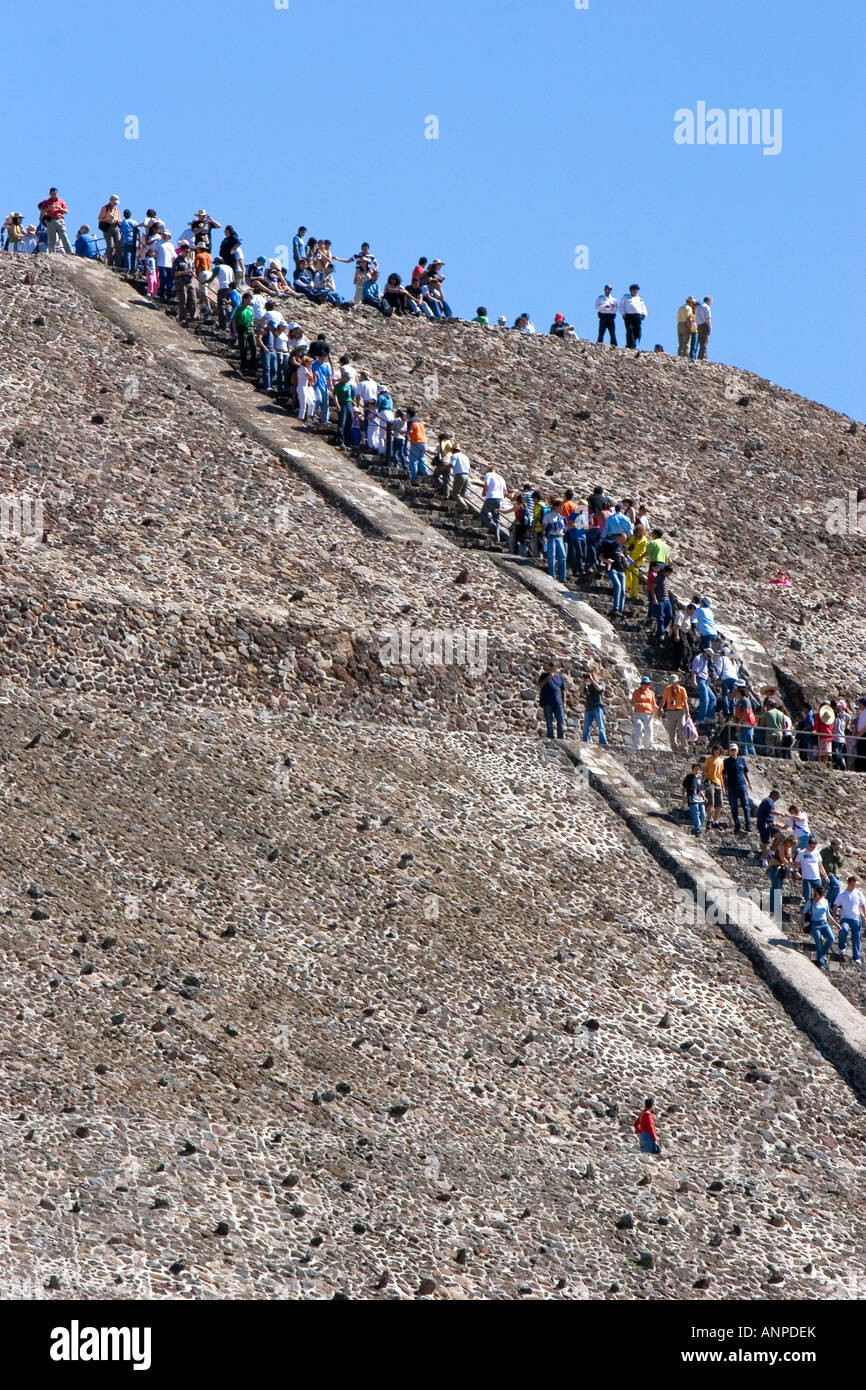 Tourists climb the steps of the Pyramid of the Sun at Teotihuacan in