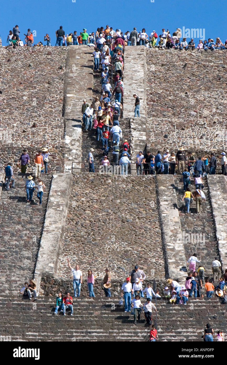 Tourists climb the steps of the Pyramid of the Sun at Teotihuacan in