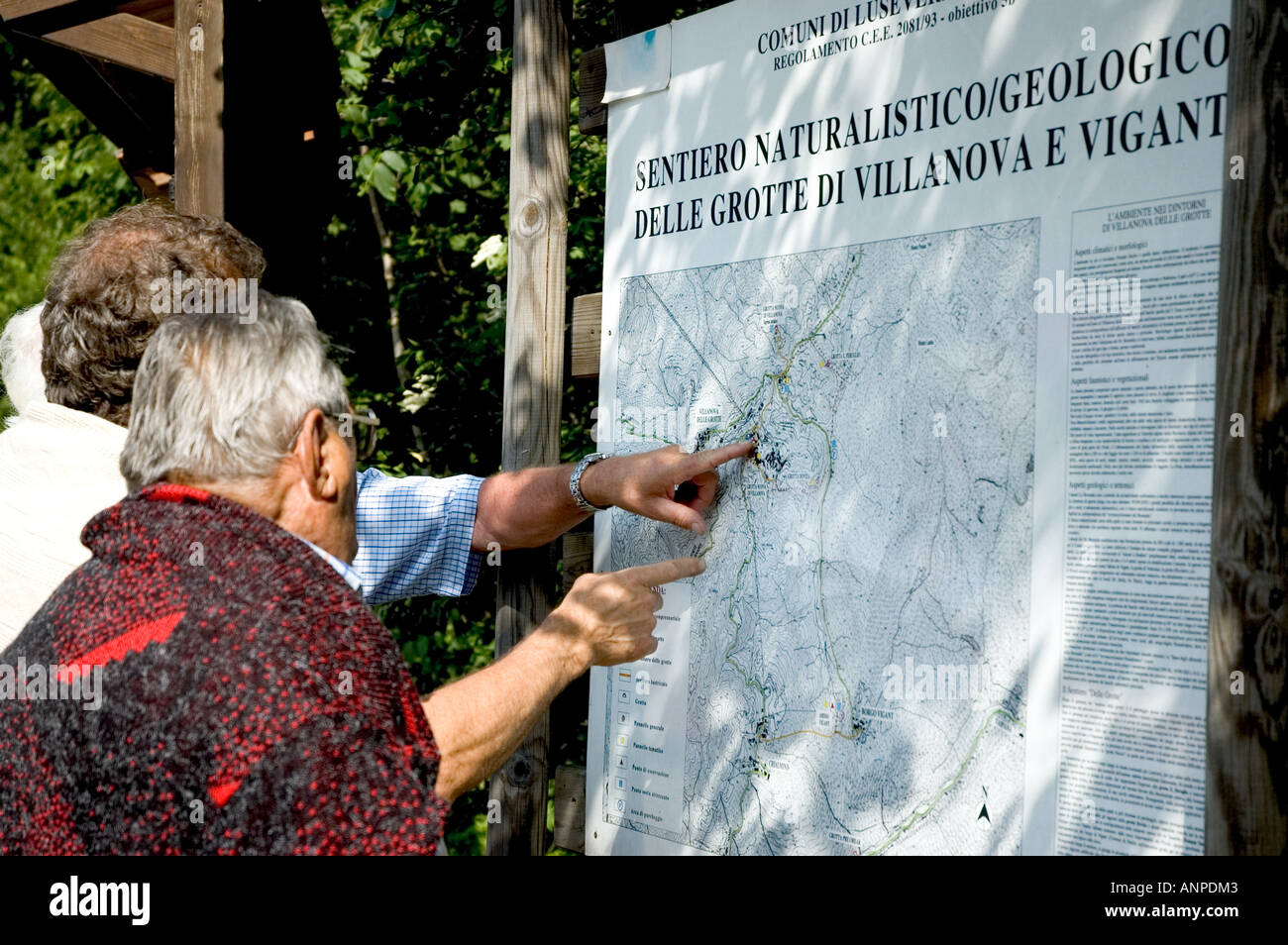 outside the cave people watch the map - sign of villanova delle grotte - friuli udine Stock Photo