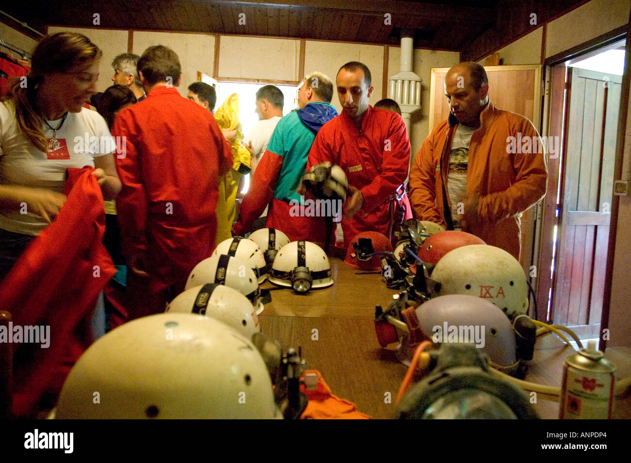 speleologists dressing the overalls and helmets of Villanova delle grotte - Friuli Udine Italy Stock Photo