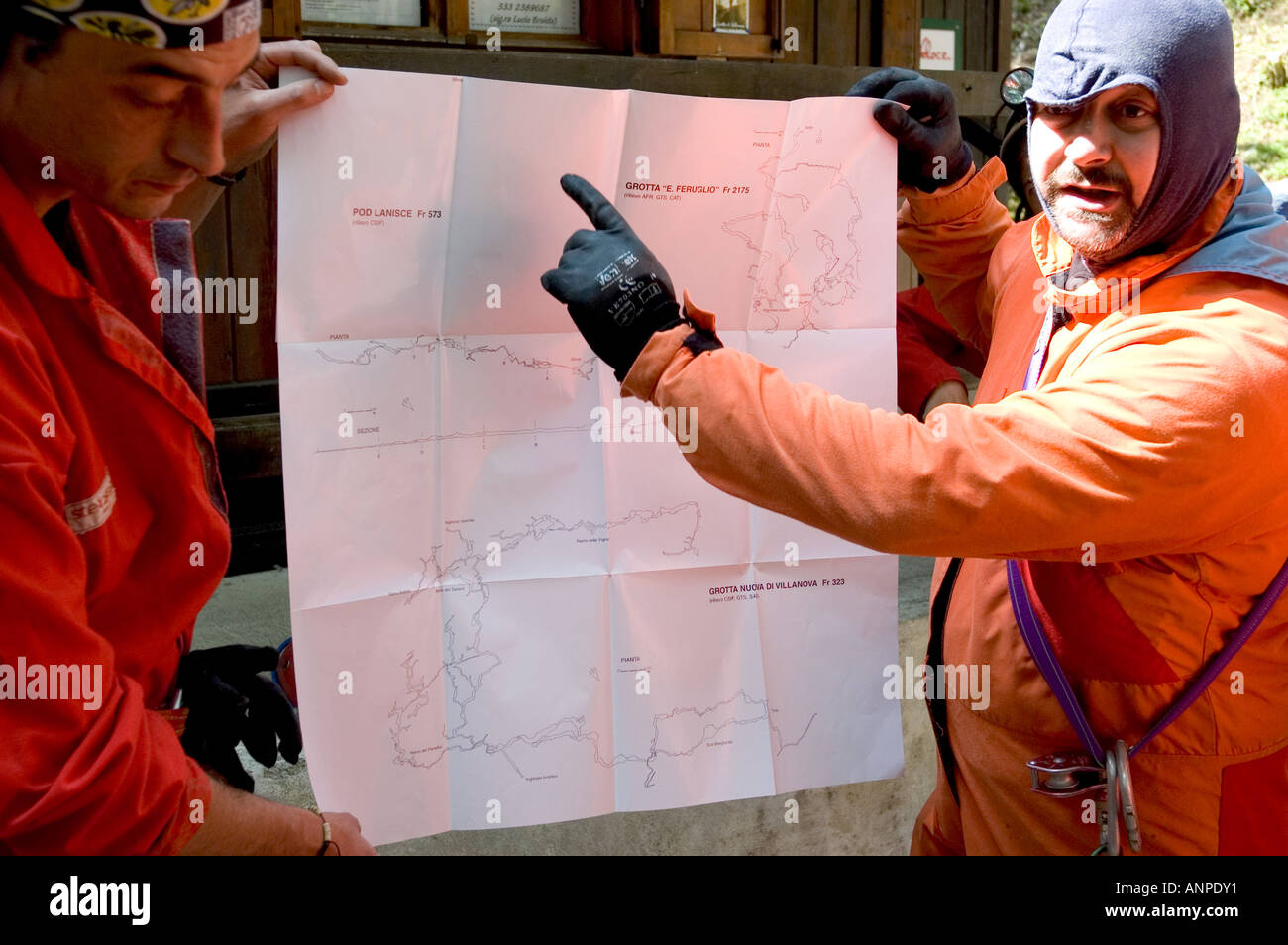 speleologists with the cave map of Villanova delle grotte - Friuli Udine Italy Stock Photo