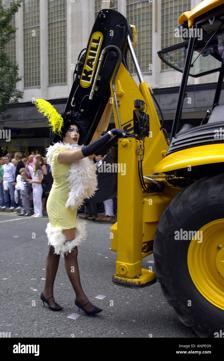 tv tranny transvestite tractor yellow black heavy machinery vehicle dress fancy dress costume gay pride mardi gras manchester de Stock Photo