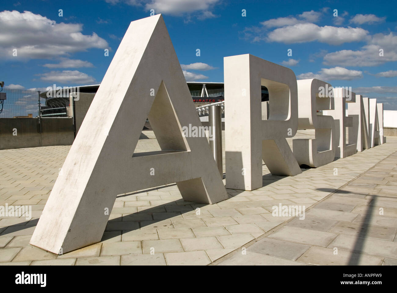 Arsenal FC football club new Emirates stadium with roadside stone sign letters across one of the approaches Holloway Islington North London England UK Stock Photo