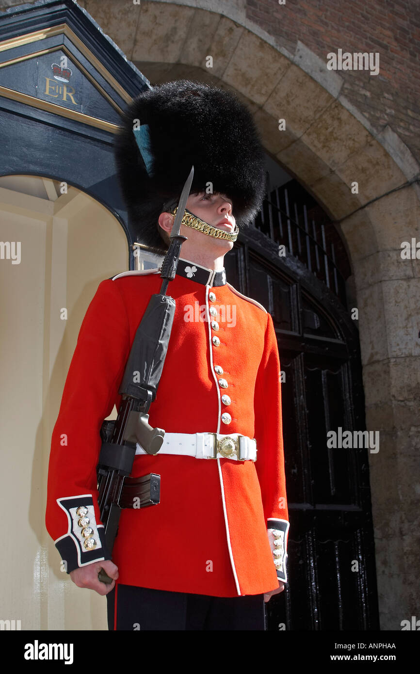 Guardsman soldier of Irish Guards on guard with fixed on rifle
