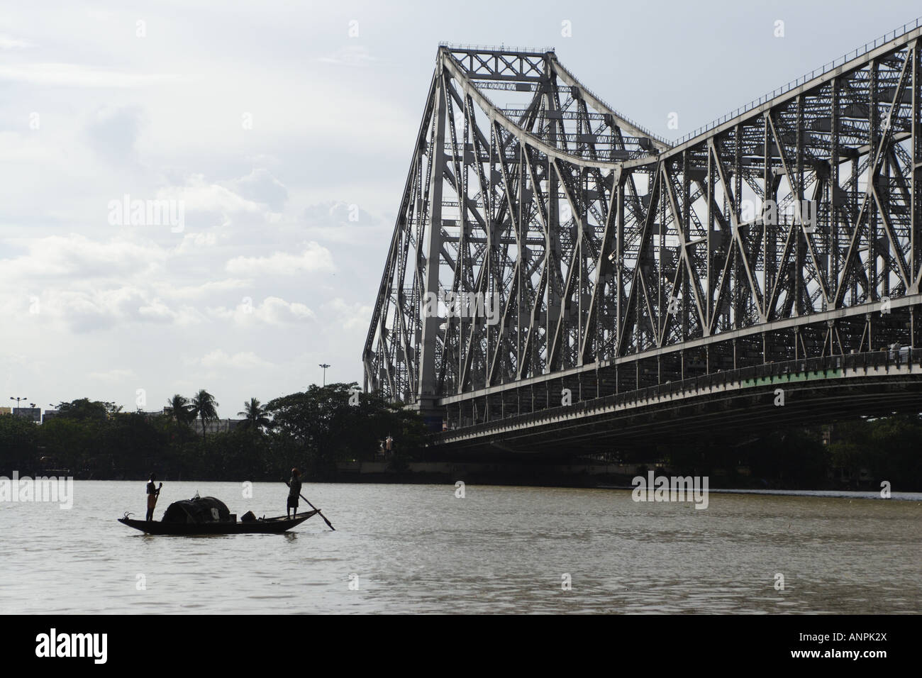A rowing boat on the Hooghly River, near to the Howrah Bridge, in Kolkata, India. Stock Photo