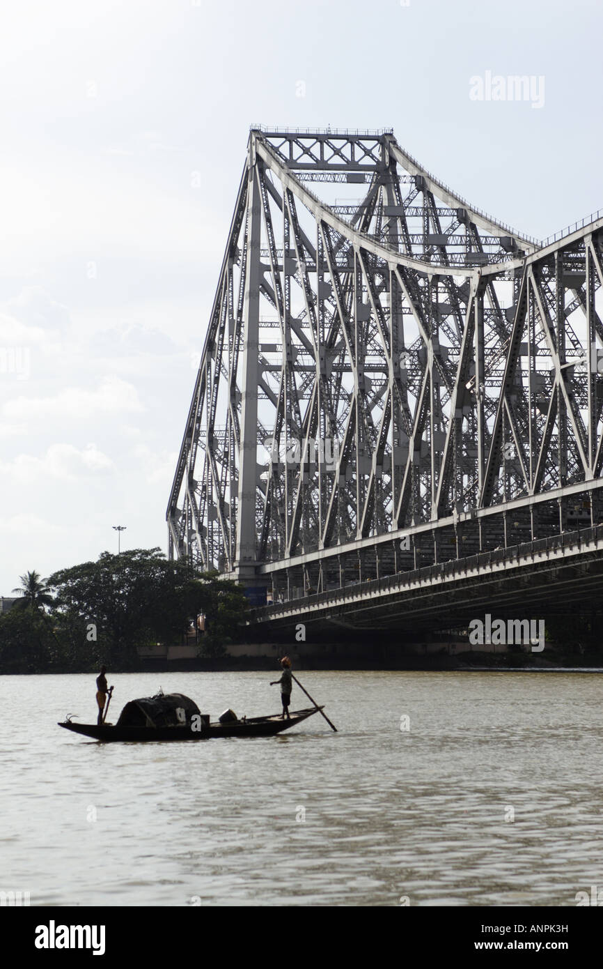 A rowing boat on the Hooghly River, near to the Howrah Bridge, in Kolkata, India. Stock Photo