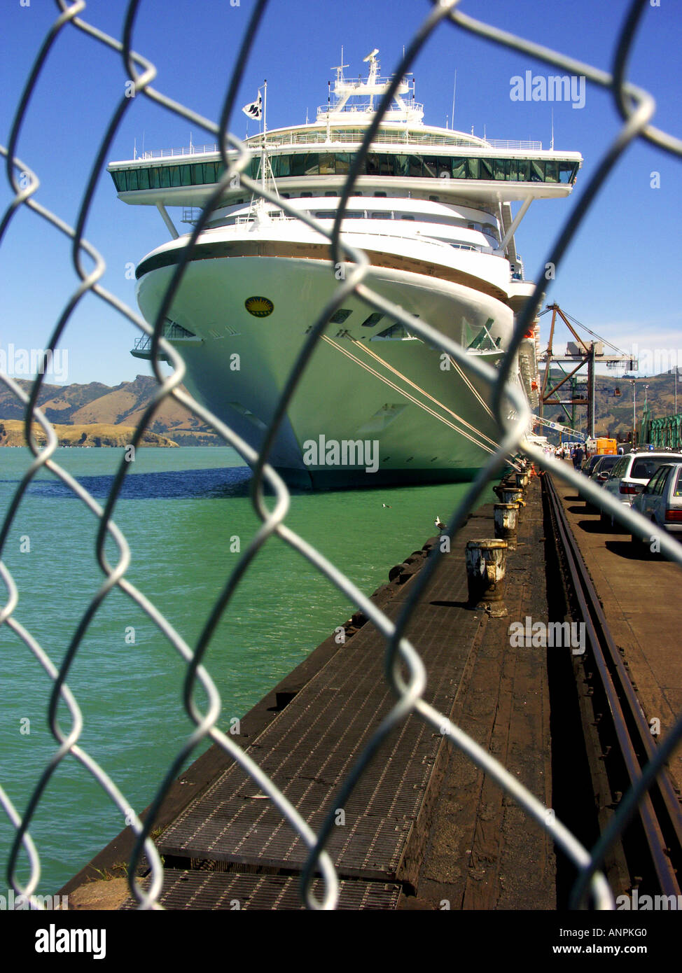 Cruise ship moored beyond security fence at Lyttelton, New Zealand. Stock Photo