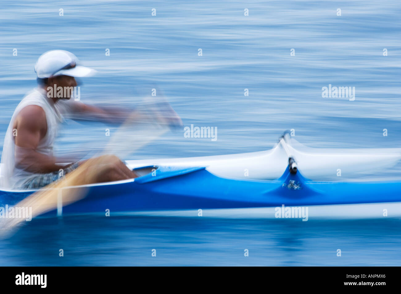single person paddling outrigger canoe, Moorea, French Polynesia Stock