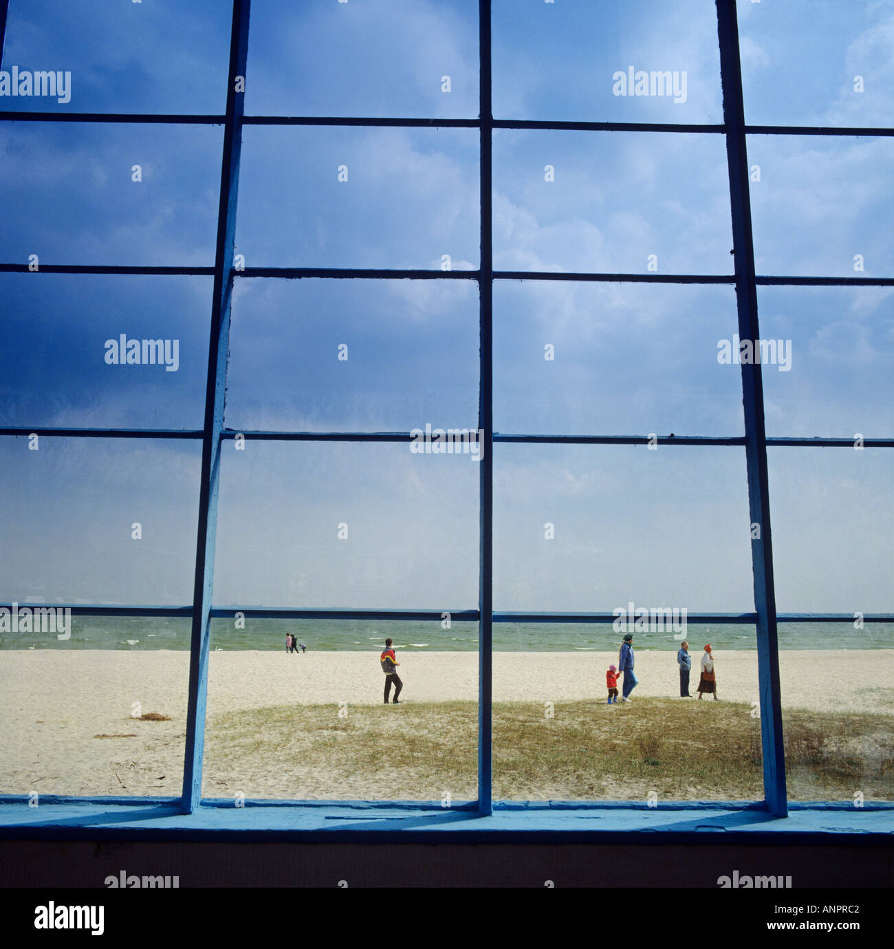 Coastline and sandy beach at Gdansk viewed through windows of a beachside public amenity Gdansk Poland Stock Photo