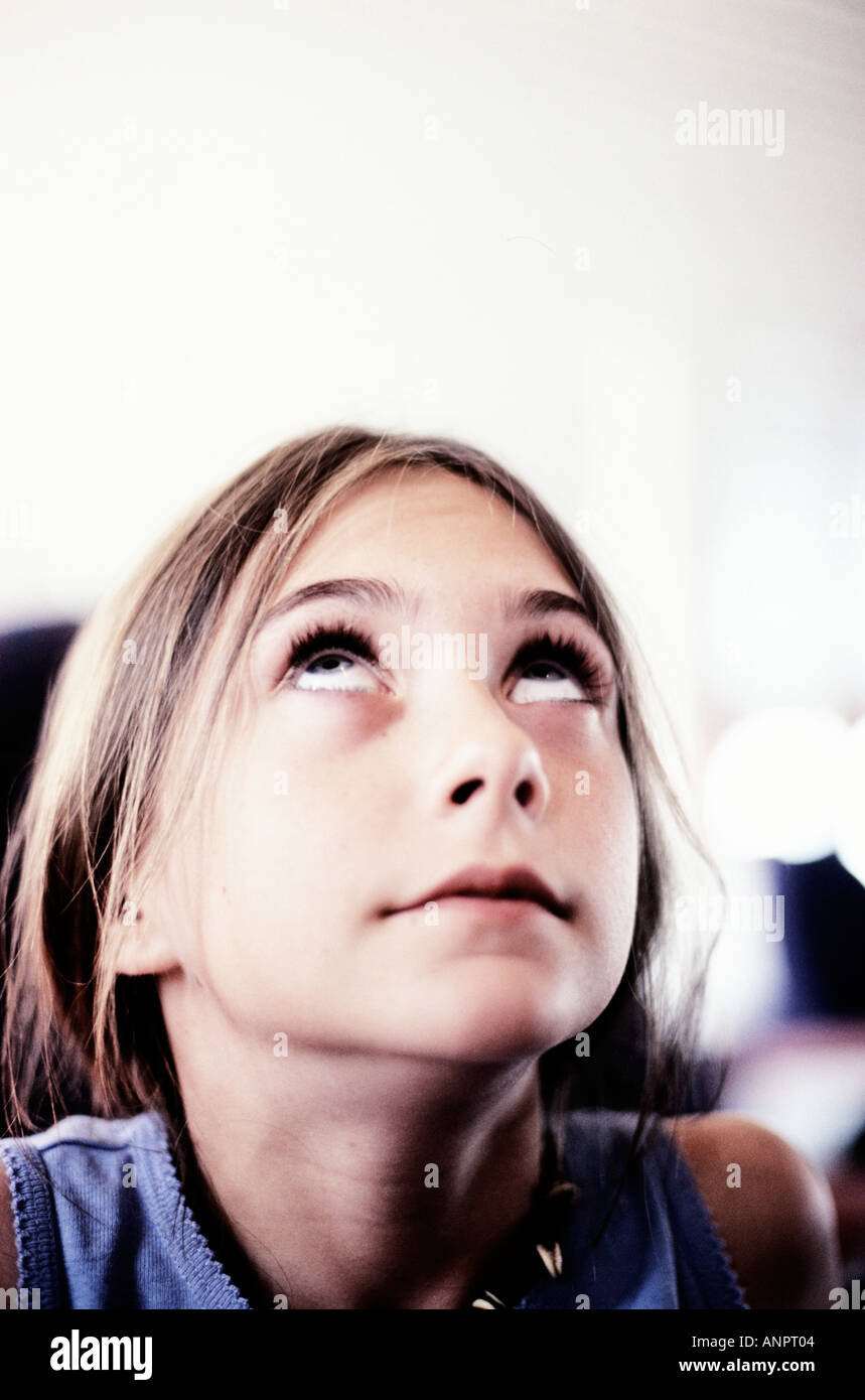 Young girl looking up to the ceiling Stock Photo