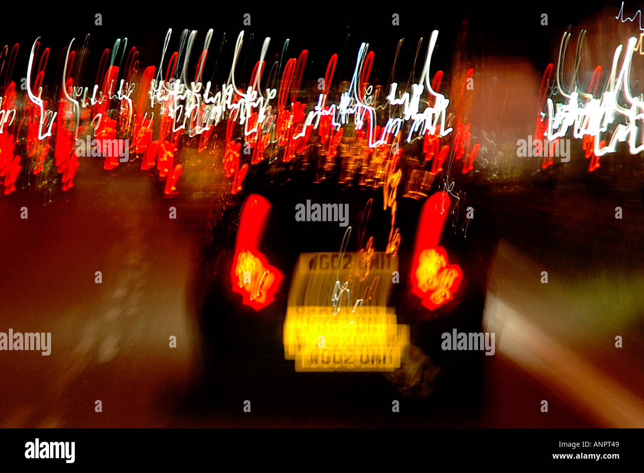 SHOT OF TRAFFIC ON MOTORWAY OR FREEWAY SHOWING STOPLIGHTS ON CAR WITH MOTION BLURRING Stock Photo