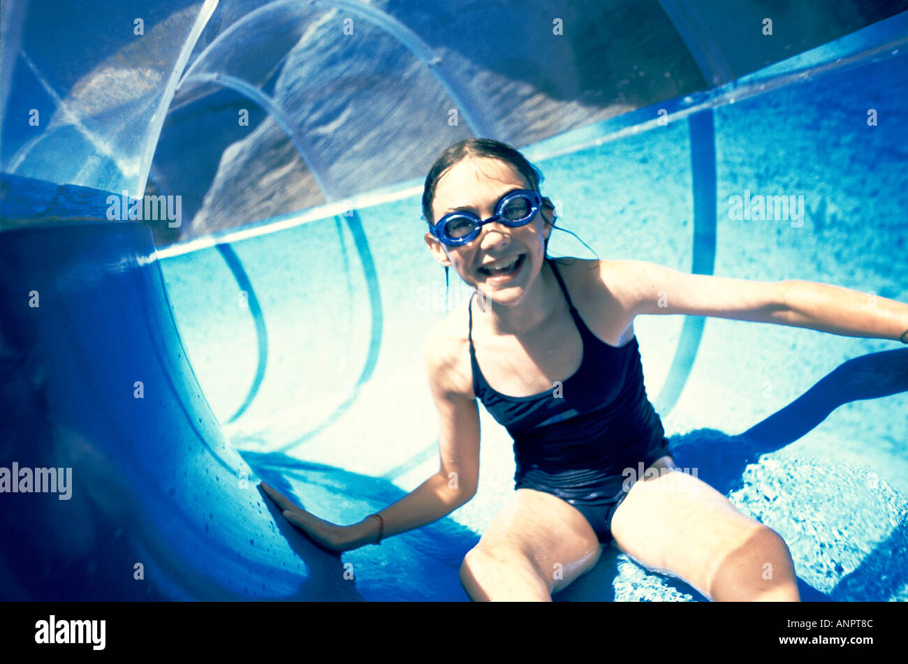 Girl on a water slide at an aqua park Stock Photo