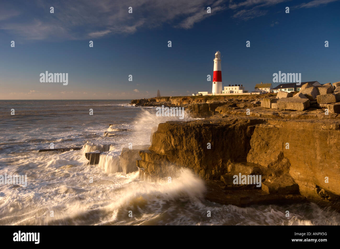 Rough seas crashing into the shoreline at Portland Bill lighthouse Dorset UK Stock Photo