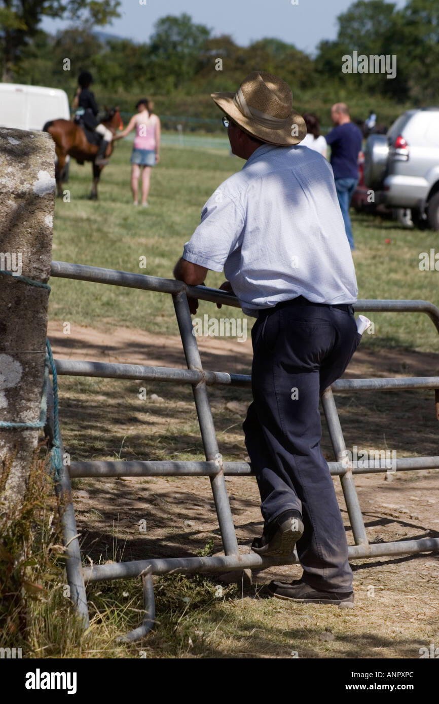 farmer in cowboy hat leaning on fence County Limerick Ireland Stock