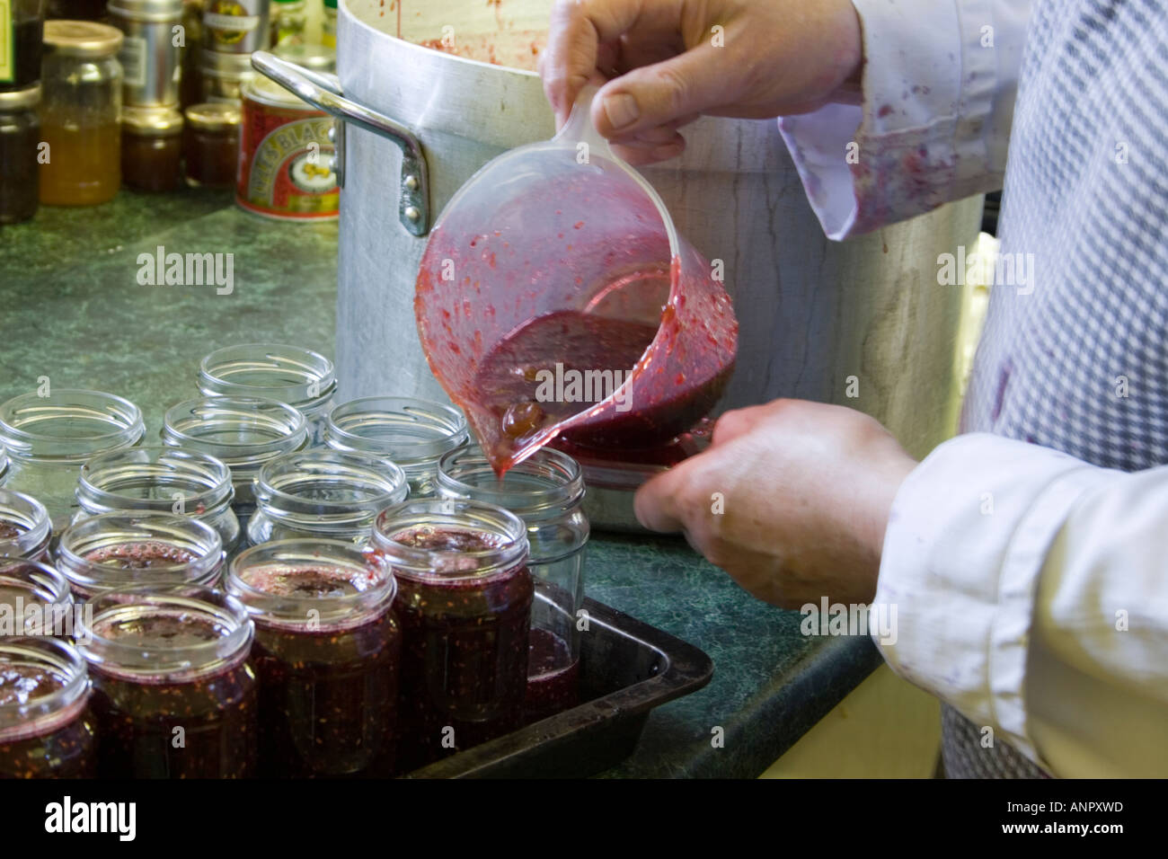 Jam making pouring boiled fruit into pots Stock Photo Alamy