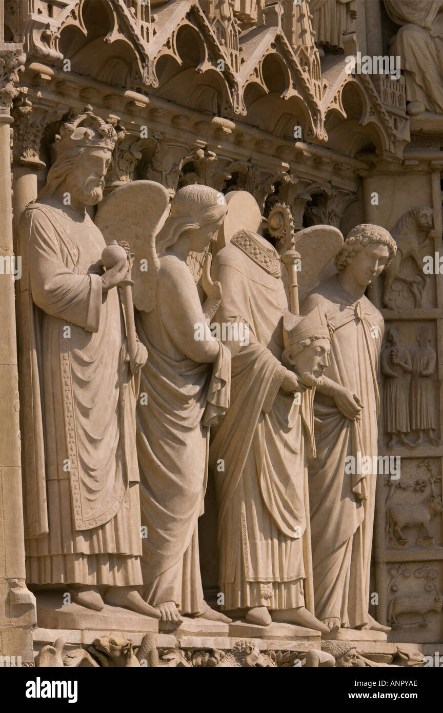 Saint Denis holding his head on the facade Notre Dame Cathedral Stock