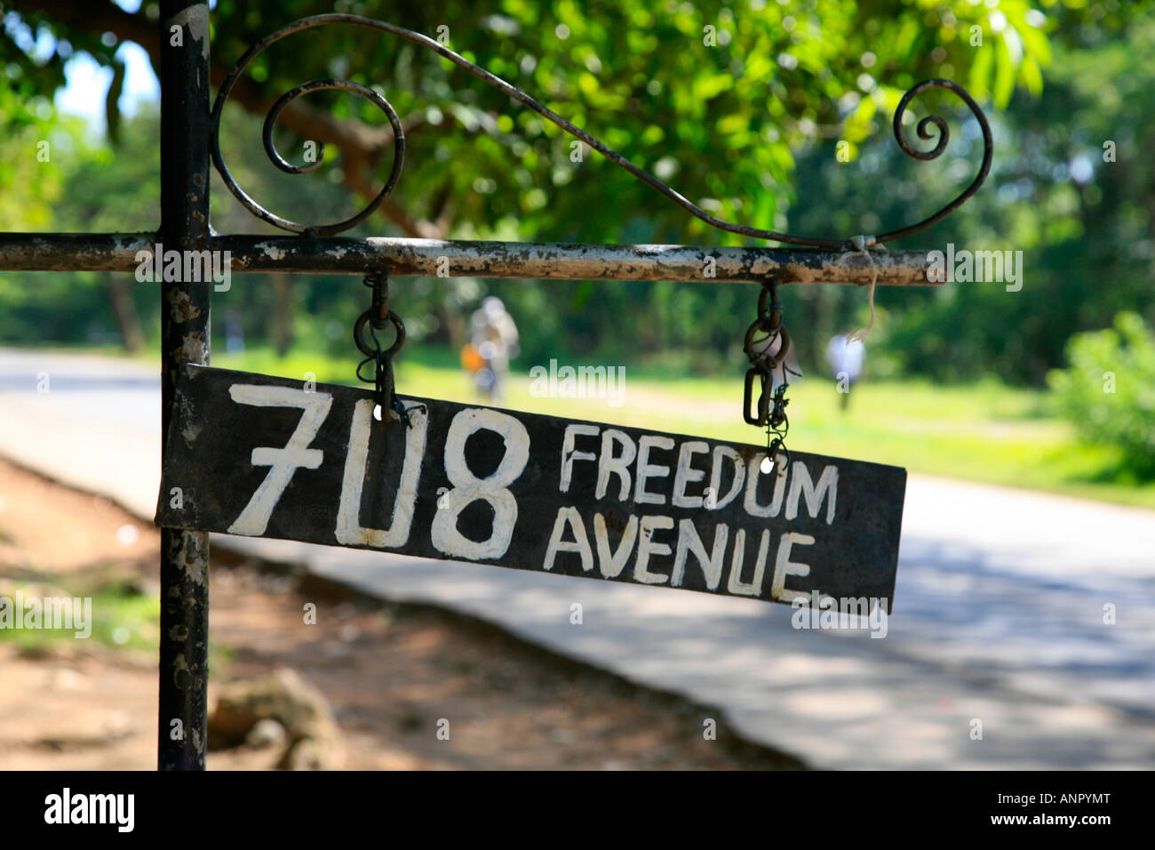 Metal address sign with hand-written letters 'Freedom Avenue 708' on big asphalt road in Kitwe city, Copperbelt province, Zambia, Southern Africa Stock Photo