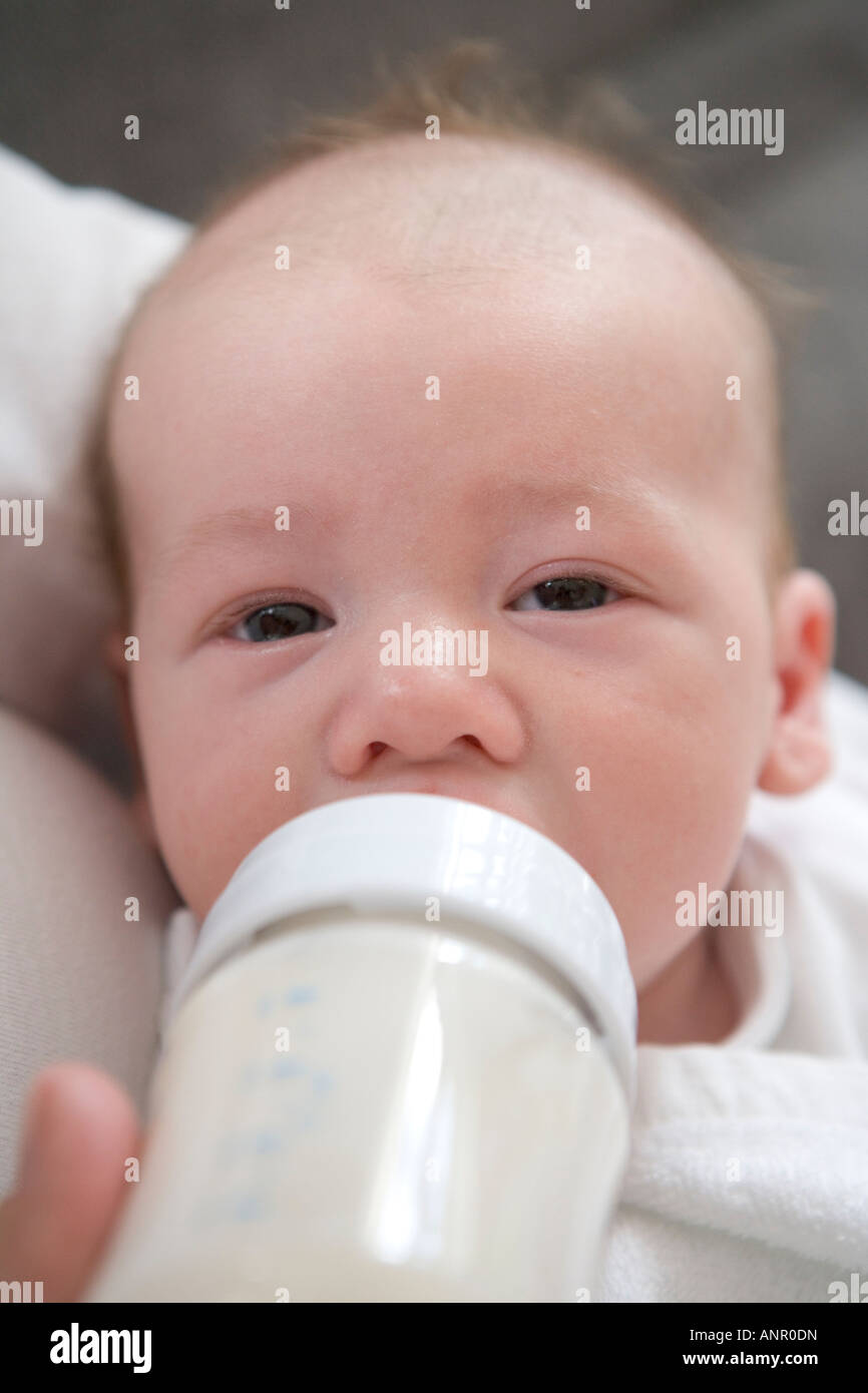 Baby gets bottle feeding Stock Photo Alamy