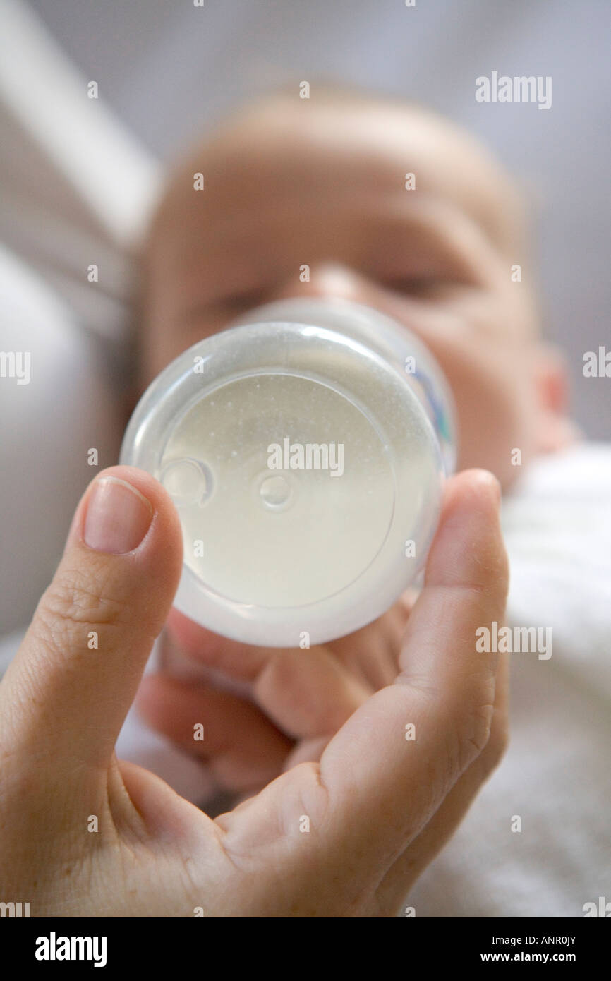 Baby gets bottle feeding Stock Photo Alamy