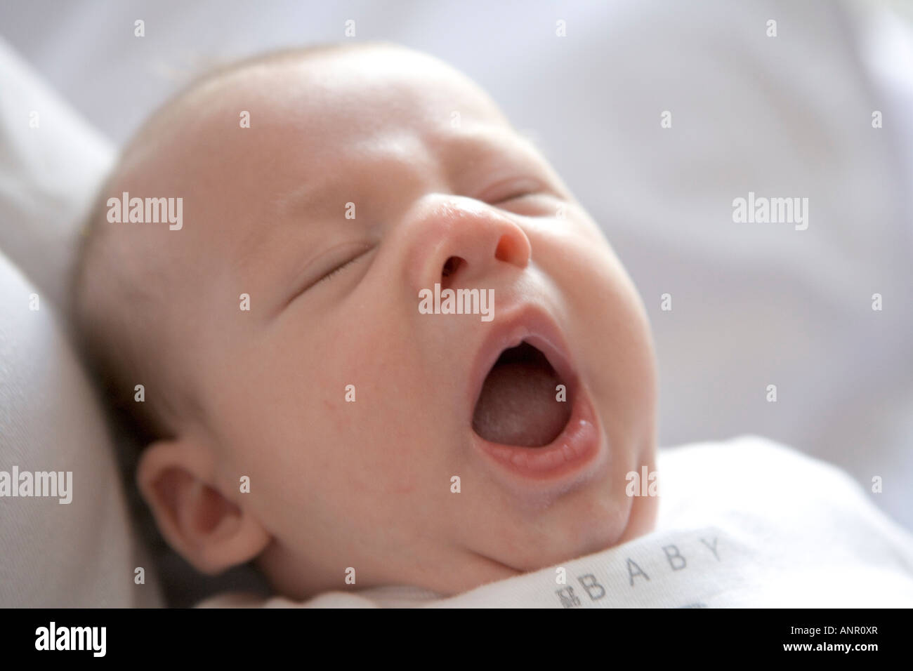 Portrait of a yawning newborn baby Stock Photo