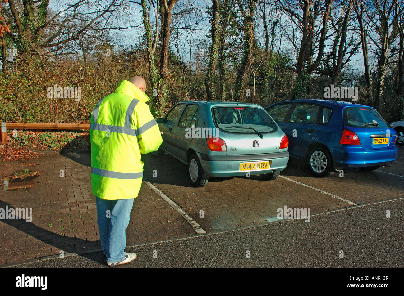 Car Park attendant recording car registration numbers Stock Photo Alamy