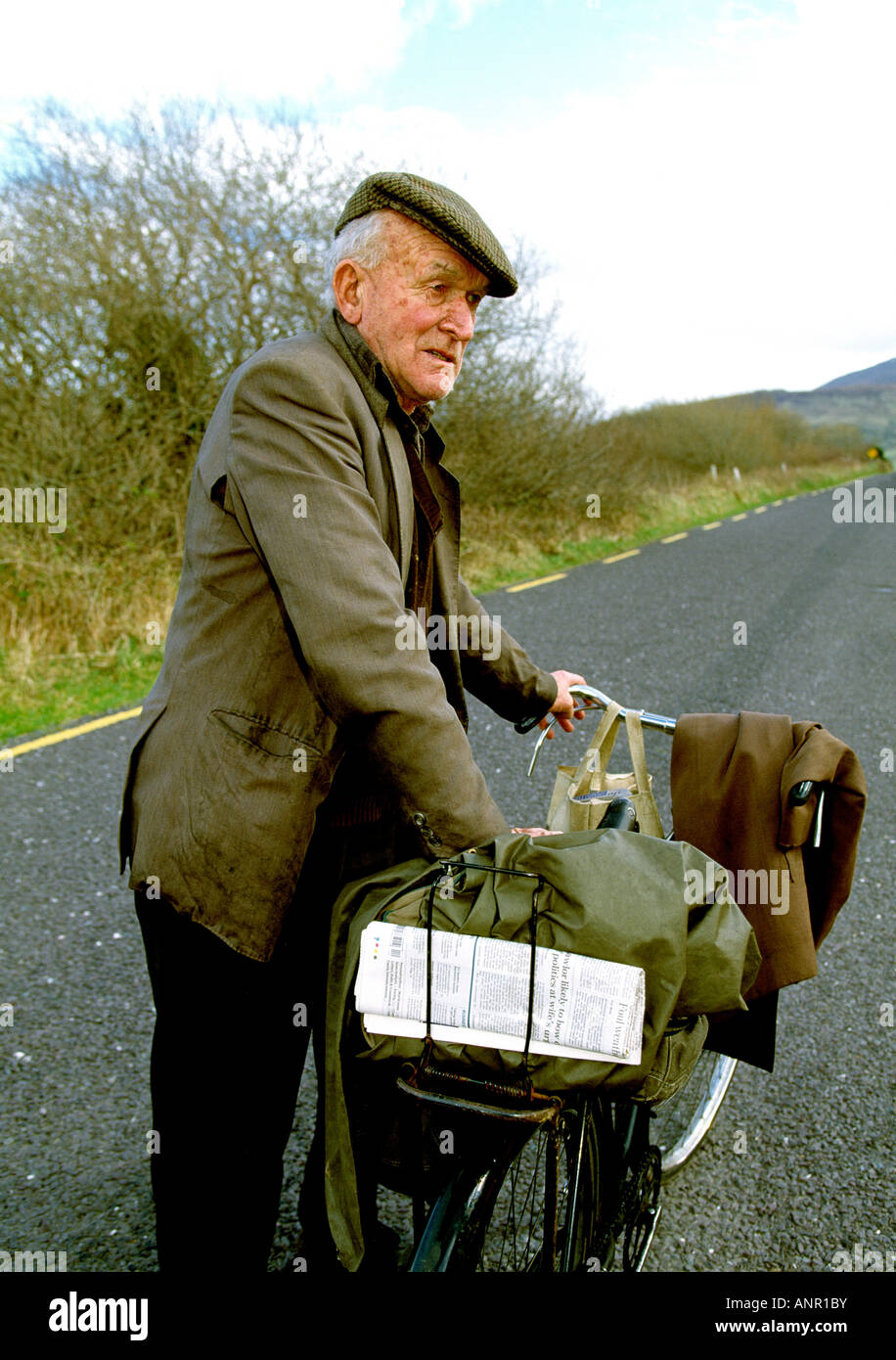 old man with bicycle on an irish rural road, Stock Photo