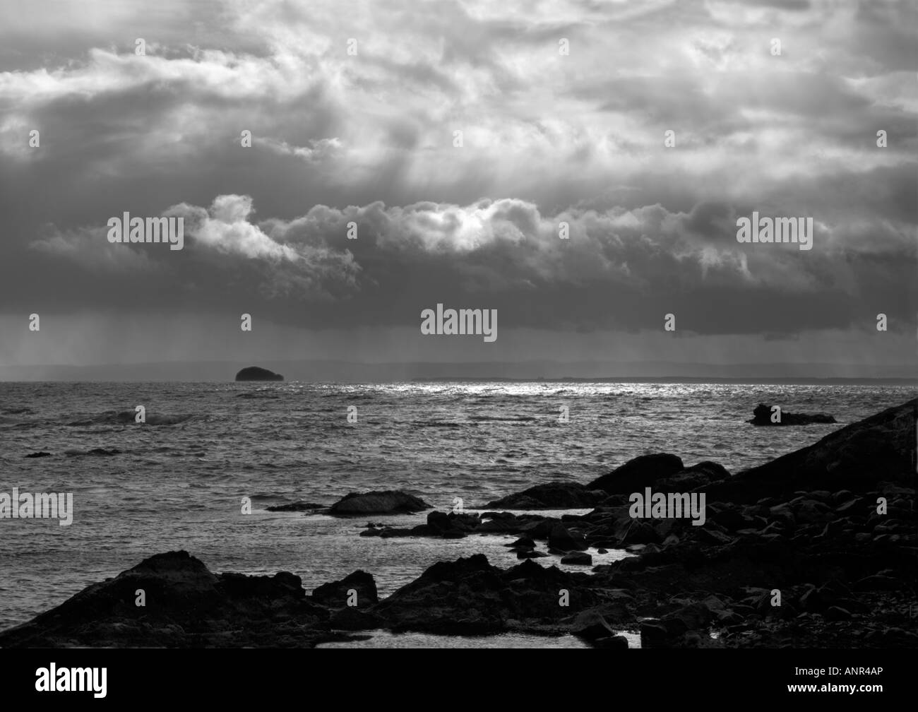 stormy seashore at Pittenweem Scotland with distant view of Bass Rock Stock Photo