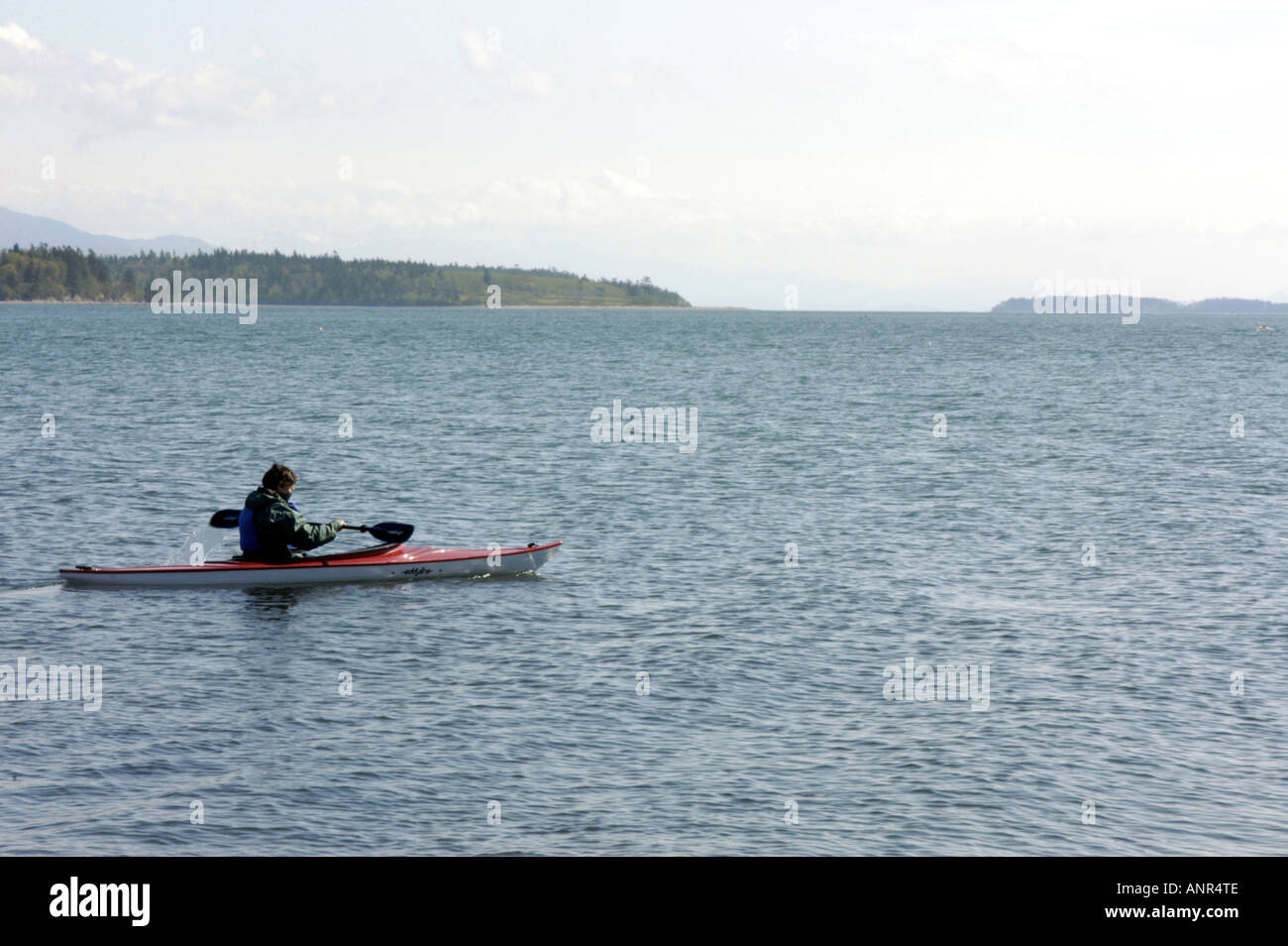 Washington San Juan Islands Woman sea kayaking near Lummi Island Stock Photo
