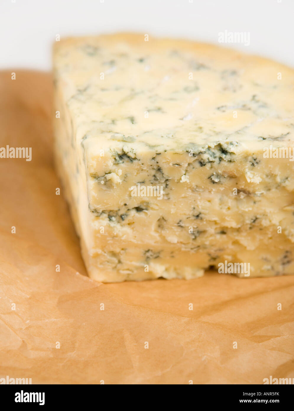 English Stilton a rich, waxy, white cheese, veined with blue mold