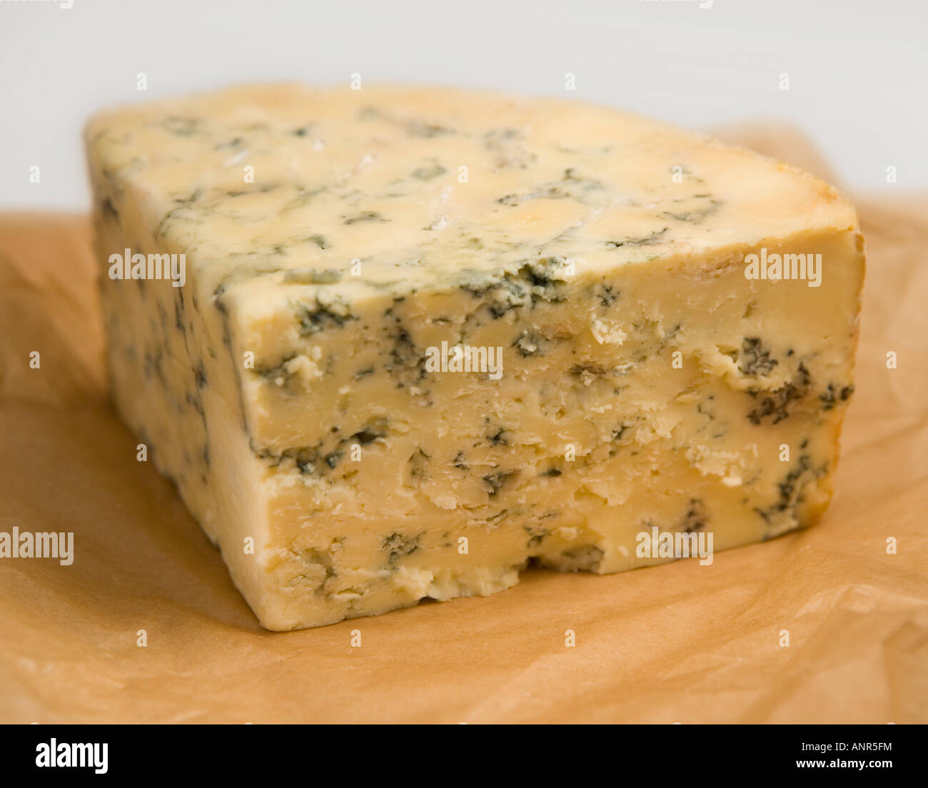 English Stilton a rich, waxy, white cheese, veined with blue mold