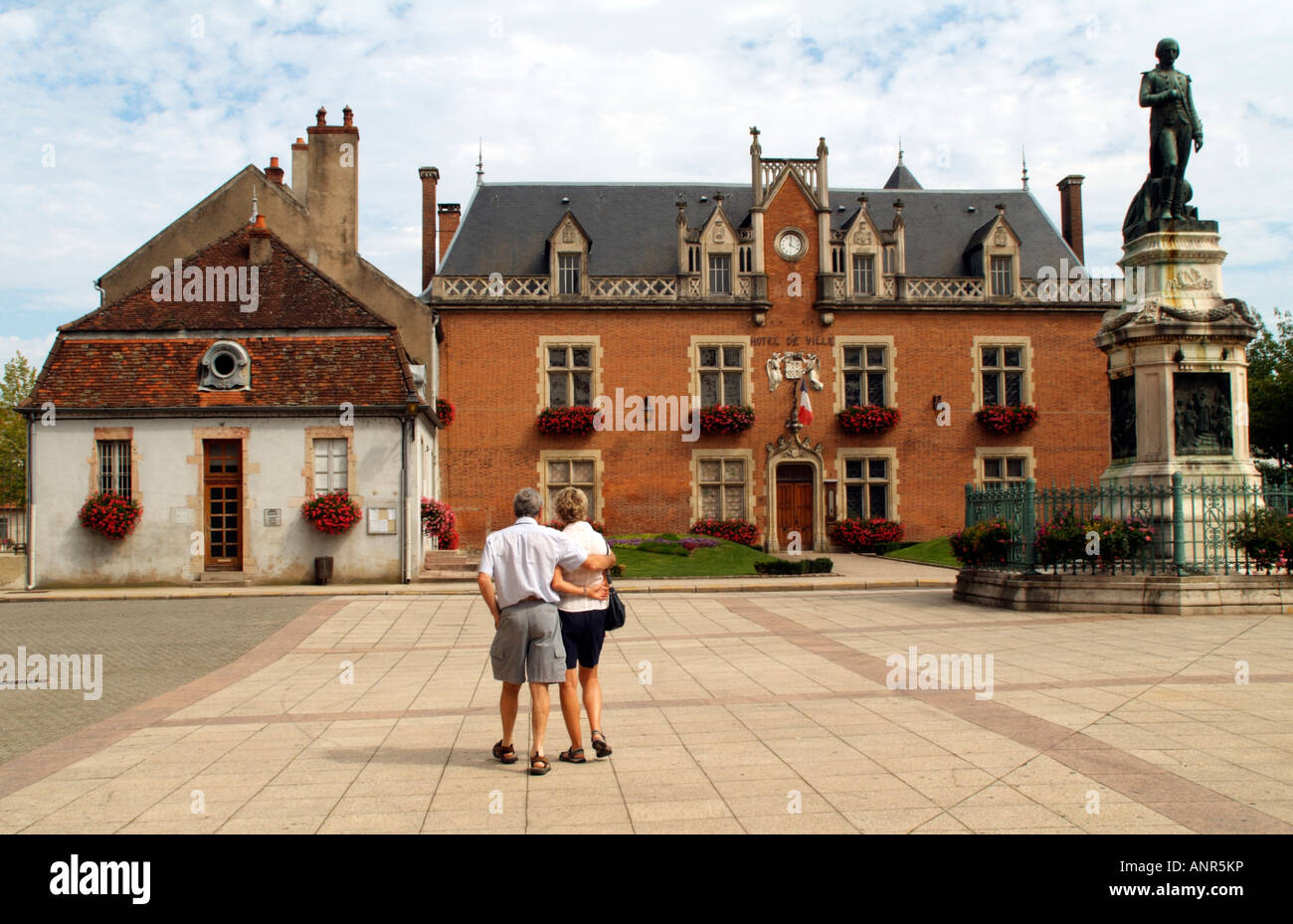The Hotel de Ville at Auxonne in France and Tourists Stock Photo