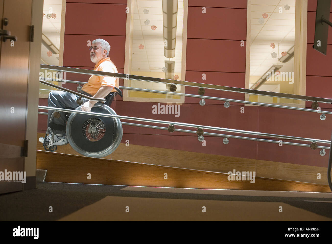 Side profile of a middle-aged man sitting in a wheelchair on a ...