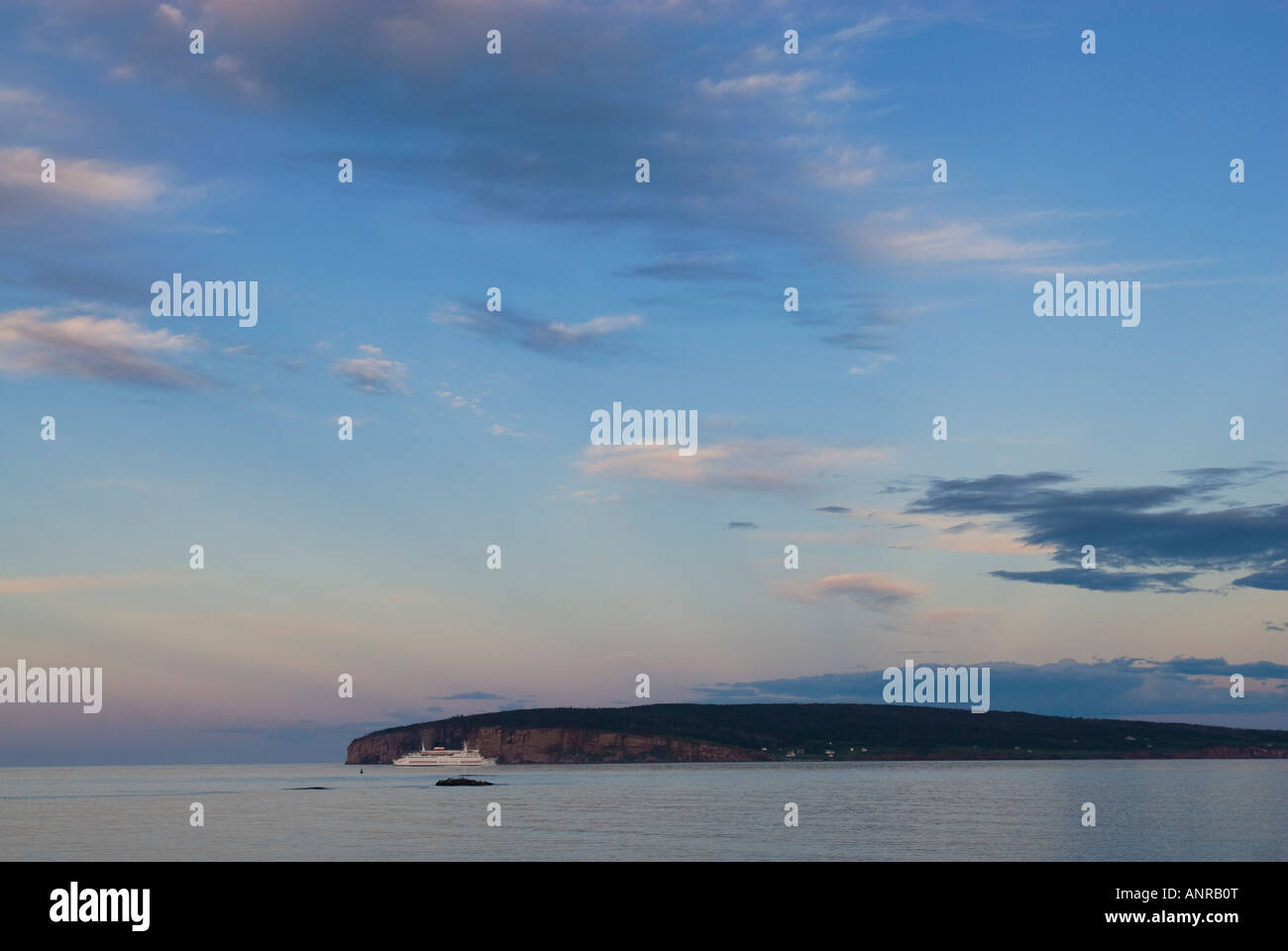 A ship passes Bonaventure Island near Perce off Quebec province's Gaspe peninsula, Canada. Stock Photo