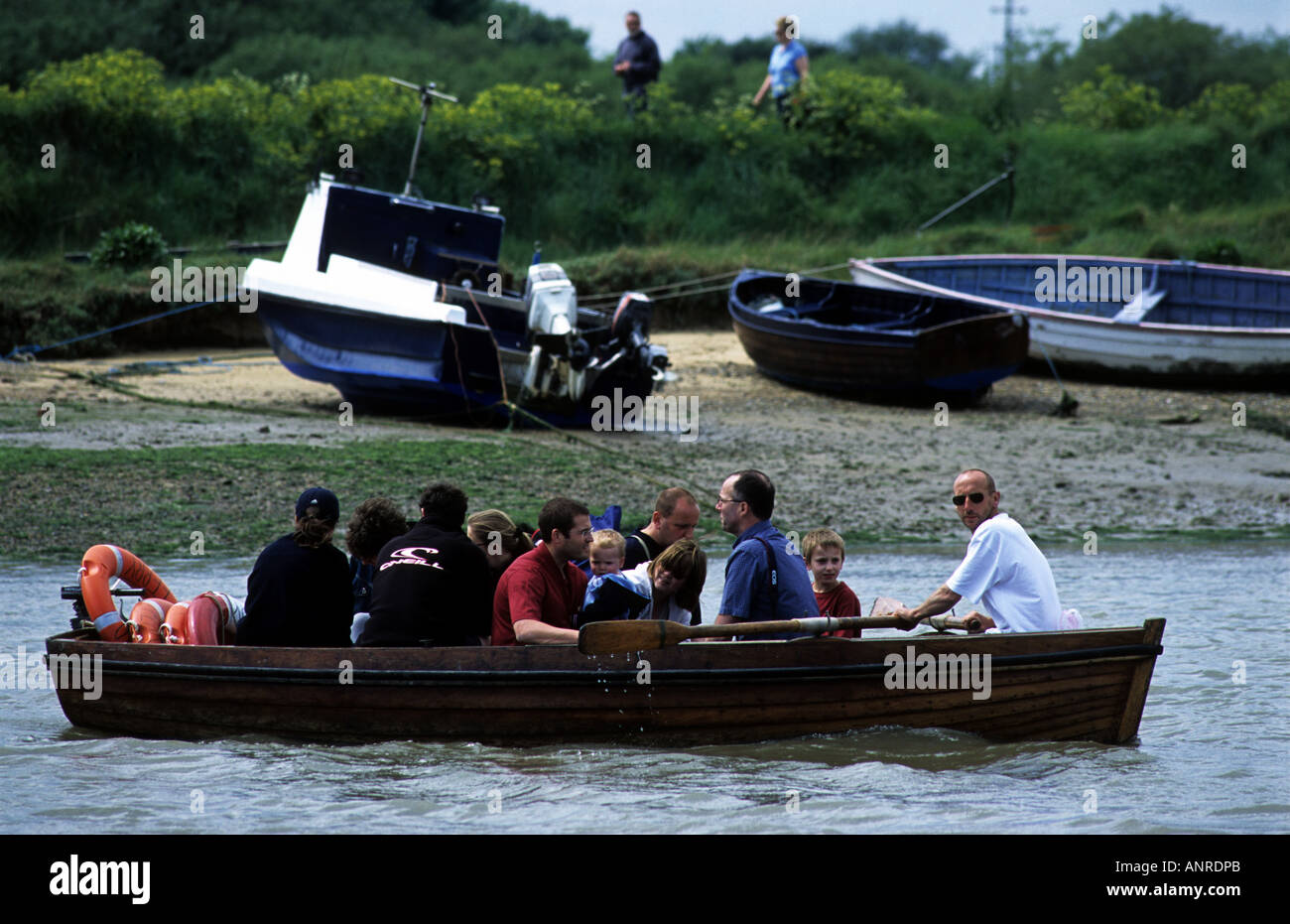 Ferryman at Walberswick rowing passengers the short distance to Southwold, Suffolk, UK. Stock Photo